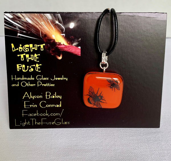 Orange pendant with playful bees